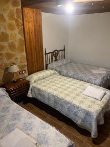 A bed or beds in a room at Alojamiento Rural El Chorrillo