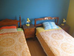 a bedroom with two beds and two night stands at Posada Peregrinus in Lima +62 photos