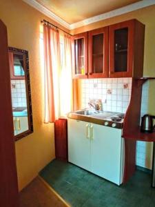 a small kitchen with a sink and a window at Villa Europa in Mielno