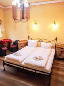 a bedroom with a bed with two pillows on it at Villa Europa in Mielno