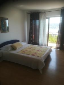 Postel nebo postele na pokoji v ubytování Apartmani Huljev