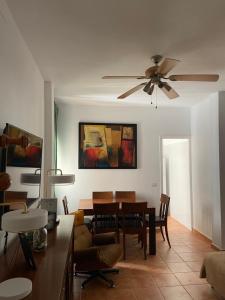 a living room with a ceiling fan and a table at Dream Ravine in Santa Cruz de Tenerife