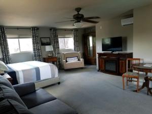 a bedroom with a bed and a flat screen tv at Ronnie's Resort in Payson