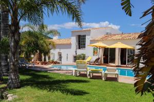 a villa with a swimming pool and a house at Idyllic Farm House with huge Garden for 14PAX in Almancil