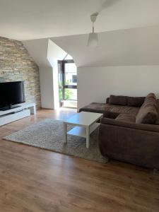 a living room with a couch and a coffee table at City Home 1 in Metzingen
