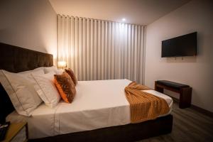 Uma cama ou camas num quarto em Quinta das Oliveiras Turismo Rural