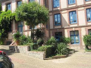 Un edificio con un montón de plantas delante. en Studio Barbel, en Honfleur