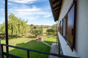 a balcony of a house with a view of a yard at Home Holiday La Selva in Cassano Spinola