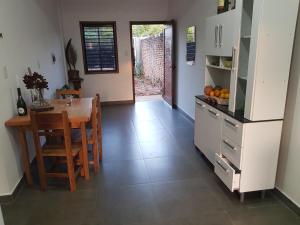 a kitchen with a table and a dining room at Casa Naranja in San Lorenzo