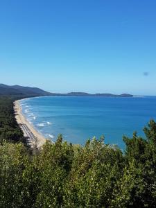 a view of the beach from a bluff at Vacanza nella Natura in Punta Ala