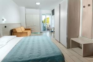 a bedroom with a bed and a living room at Residence Clipper in Giulianova