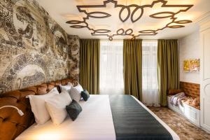 a bedroom with a large bed with a large chandelier at Art Boutique Hotel Gallery 37 Plovdiv - Superb Location in the Old Town in Plovdiv