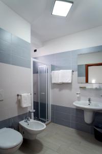a bathroom with a toilet and a sink and a shower at Residence Clipper in Giulianova