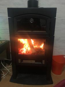 a black stove with a fire in it at Atlantida casi en la playa in Atlántida