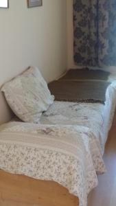 um pequeno quarto com uma cama com um cobertor em Hotel y Cabañas La Rosa Nautica em Pichidangui