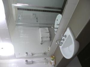 a bathroom with a sink, toilet and mirror at Springs Mittagong in Mittagong