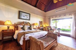 ein Schlafzimmer mit großem Bett und Fenster in der Unterkunft Sun Spa Resort & Villa in Dong Hoi