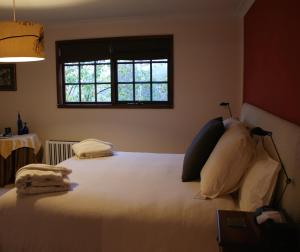 a bedroom with a large white bed with a window at Bundanoon @2578 in Bundanoon