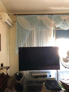 A television and/or entertainment centre at CAPO PELORO RELAX