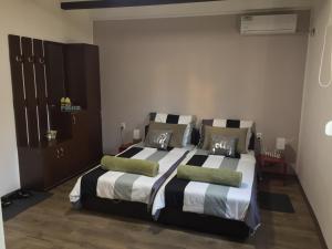 a bedroom with two beds with pillows on them at Alex Lodge in Zrenjanin