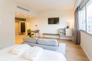 a living room with a bed and a couch at ARTIEM Madrid in Madrid