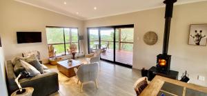 a living room with a living room with a fireplace at Maitlands Cottage in Port Elizabeth