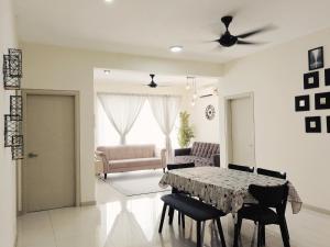 a living room with a table and chairs at 3 Bedrooms FULLY AIRCOND,near MSU , Shah Alam stadium in Shah Alam