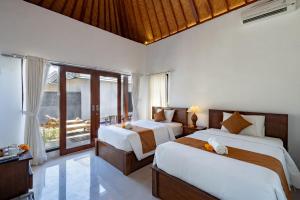 珀尼达岛WK Gamat Garden的一间带两张床和阳台的卧室 更多71张照片