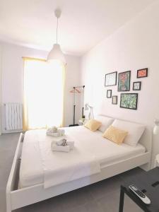 a white bedroom with a large white bed in a room at Casa Pirri in Palermo