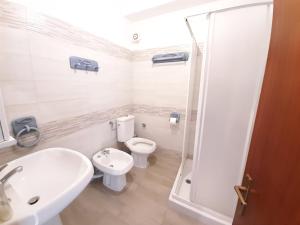 a bathroom with a toilet and a sink and a shower at CASA VACANZE ANDREANA in Letojanni +29 photos