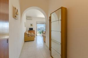 a hallway with an archway leading to a living room at CASA VACANZE ANDREANA in Letojanni
