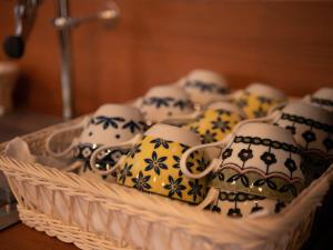 a basket of tea cups and mugs on a table at Hotel Front Inn Fukuoka Airport in Fukuoka