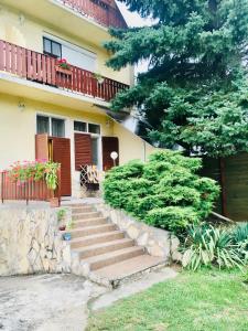 a house with stairs in front of it at Sunny & Green in H&eacute;v&iacute;z