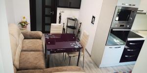 a small kitchen with a table and chairs in a room at Apartment in Varna City