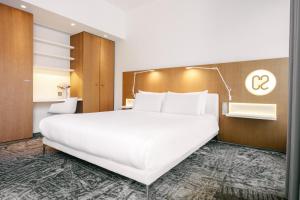 a large white bed in a hotel room at Hotel C2 in Marseille