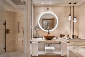 a bathroom with a sink and a mirror at Orient by Isrotel Exclusive in Jerusalem