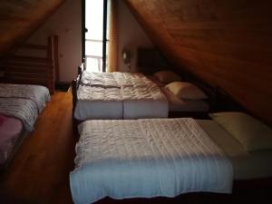 a room with three beds in a attic at Kuća za odmor "DRINSKI KONAK" - Zvorničko jezero - Drina in Zvornik +53 photos
