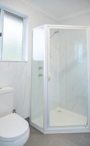 a white bathroom with a shower and a toilet at The Sleeping Lady Private Retreat in Porongurup