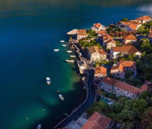 an aerial view of a village on the water with boats at Apartments Villa Serventi in Tivat