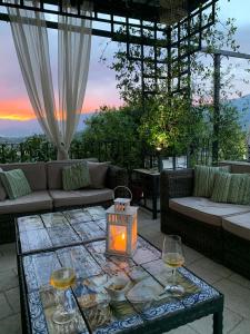 une terrasse avec une table et deux verres de vin dans l'établissement Palazzo del Senatore, à Atina