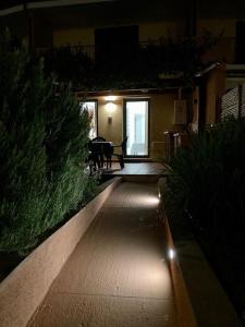 a night time view of a house with a patio at Bilocale con Giardino Olbia Mare in Olbia