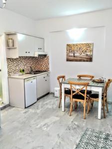 a kitchen and dining room with a table and chairs at Idomeneas Apartments in Sougia