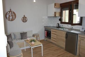 a kitchen with a couch and a table in a room at House Ekton in Pefkari +56 photos