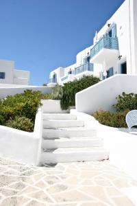 a set of white stairs in front of white buildings at Castellano Village in Analipsi