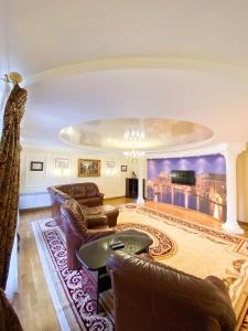 a large living room with couches and a tv at Петрос Family Hotel in Yaremche