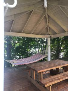 a hammock hanging from a roof on a wooden deck at Golcza Vita in Choszczno