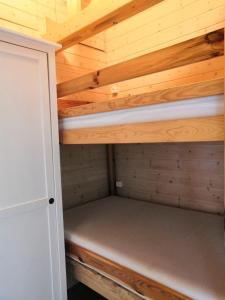 a small cabin with a bed in a wooden ceiling at Golcza Vita in Choszczno
