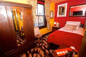 a red room with a bed and a bathroom at Fifteens of Chester in Chester