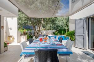 a table and chairs on a patio with a pool at Apartment Rex Exclusive in Split
