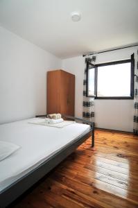 a bedroom with a bed and a window at Milosavljevic Apartments in Tivat